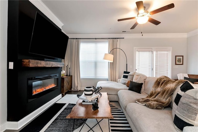 living room featuring ornamental molding and ceiling fan