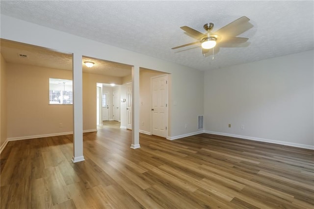 spare room featuring hardwood / wood-style floors, ceiling fan, and a textured ceiling