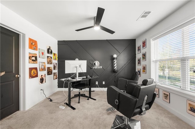 carpeted office featuring ceiling fan