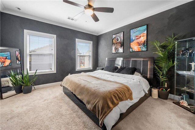 bedroom featuring ceiling fan, carpet floors, and crown molding