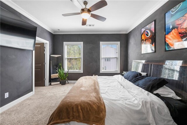 bedroom with carpet flooring, ceiling fan, and crown molding