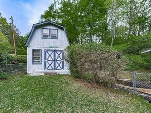 view of outbuilding with a yard