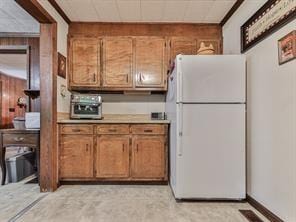 kitchen featuring wooden walls and white refrigerator