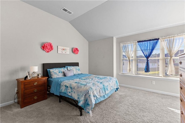 carpeted bedroom with lofted ceiling