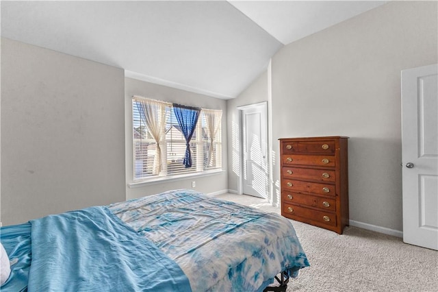 carpeted bedroom featuring vaulted ceiling