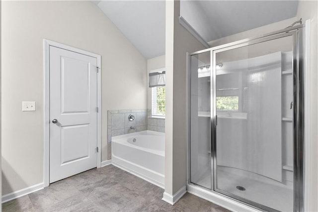 bathroom with lofted ceiling and shower with separate bathtub