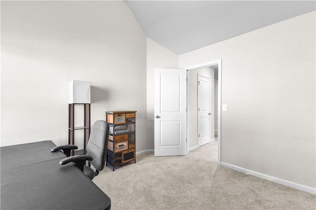 home office featuring light colored carpet and vaulted ceiling