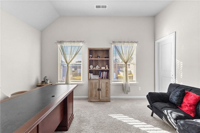 carpeted home office with lofted ceiling