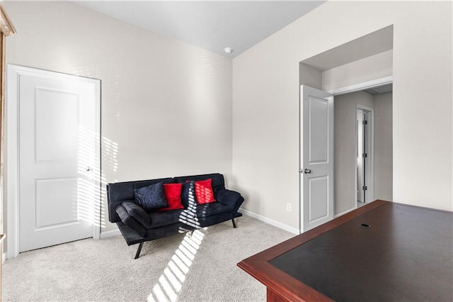 sitting room featuring light colored carpet