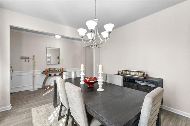 dining space featuring hardwood / wood-style flooring and a notable chandelier