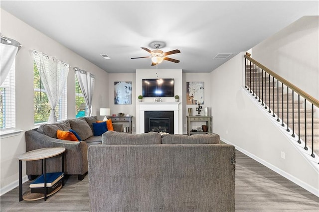 living room featuring hardwood / wood-style floors and ceiling fan