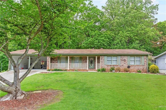 single story home featuring covered porch, a front yard, brick siding, concrete driveway, and a carport