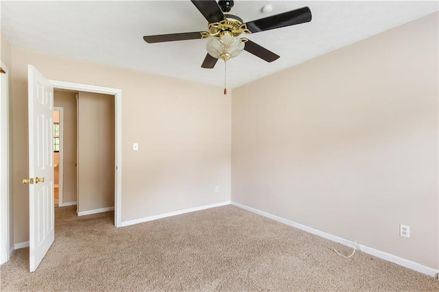 empty room with baseboards and light colored carpet