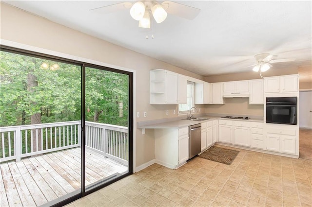 kitchen featuring stainless steel dishwasher, oven, a ceiling fan, and gas stovetop