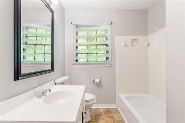 full bathroom with toilet, baseboards, tub / shower combination, and vanity