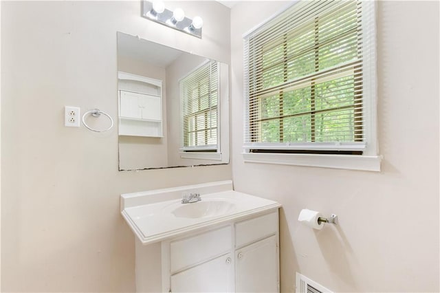 bathroom with vanity and a healthy amount of sunlight
