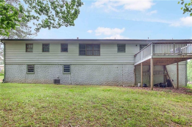 rear view of property with a yard, a deck, and cooling unit