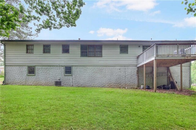 back of property featuring a yard, central AC, and a deck