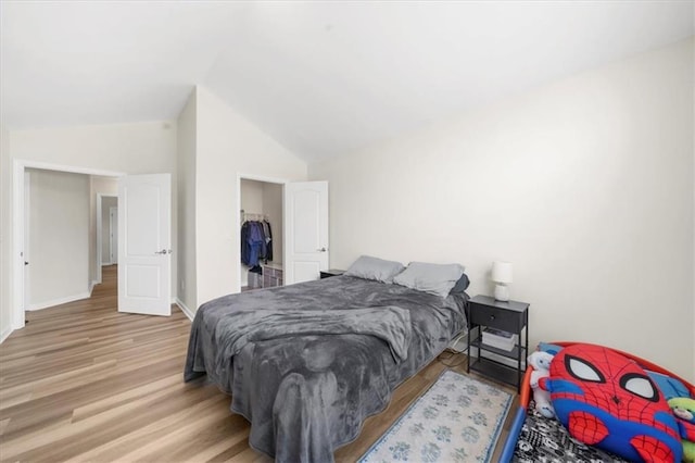 5155 Scenic View Rd, Flowery Branch, GA 30542 - bedroom with vaulted ceiling, wood finished floors, and baseboards