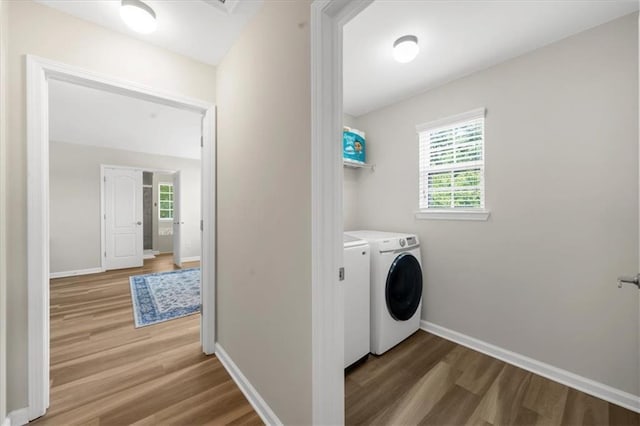 5155 Scenic View Rd, Flowery Branch, GA 30542 - laundry area with wood finished floors, washer and dryer, plenty of natural light, and baseboards