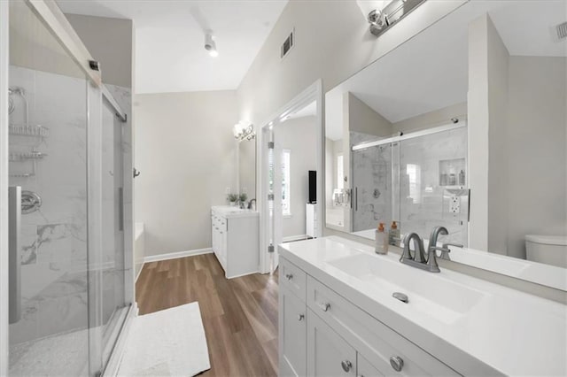 5155 Scenic View Rd, Flowery Branch, GA 30542 - bathroom with wood finished floors, a stall shower, vanity, and toilet