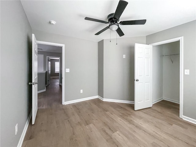 unfurnished bedroom with a ceiling fan, baseboards, and light wood finished floors