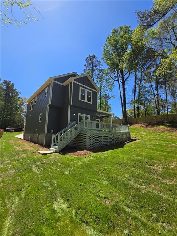 113 Miller Rd, Stockbridge, GA 30281 - rear view of house featuring a yard, fence, a deck, and stairway