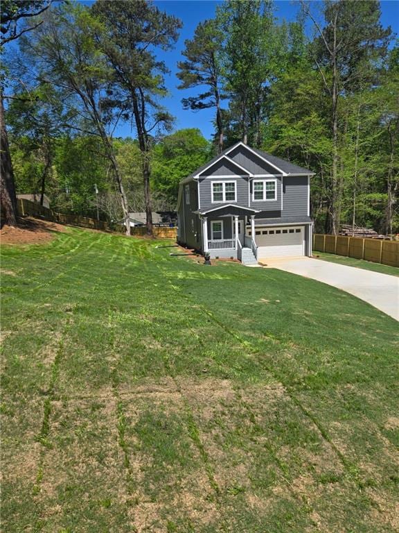 113 Miller Rd, Stockbridge, GA 30281 - view of front facade with a front lawn, driveway, fence, and a garage