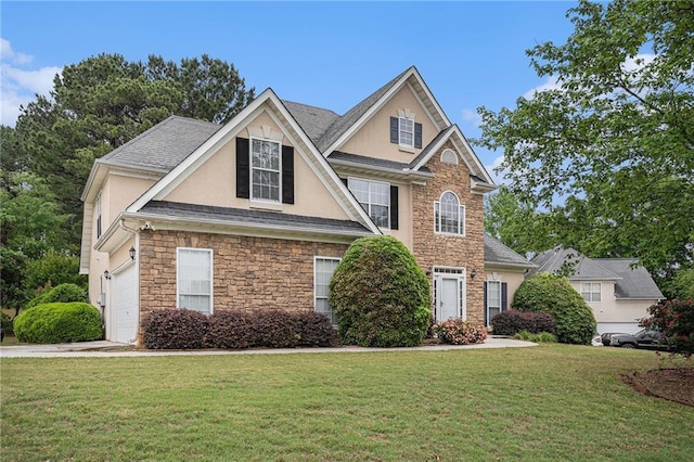 view of front of property with stucco siding, a front yard, an attached garage, and stone siding