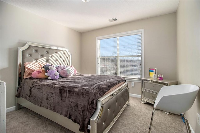 bedroom featuring baseboards, visible vents, and light colored carpet