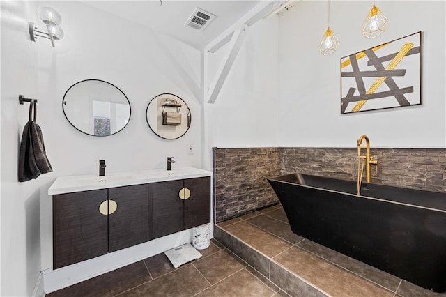 bathroom with tile patterned floors, vanity, and a bathtub