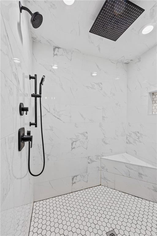 bathroom with a tile shower