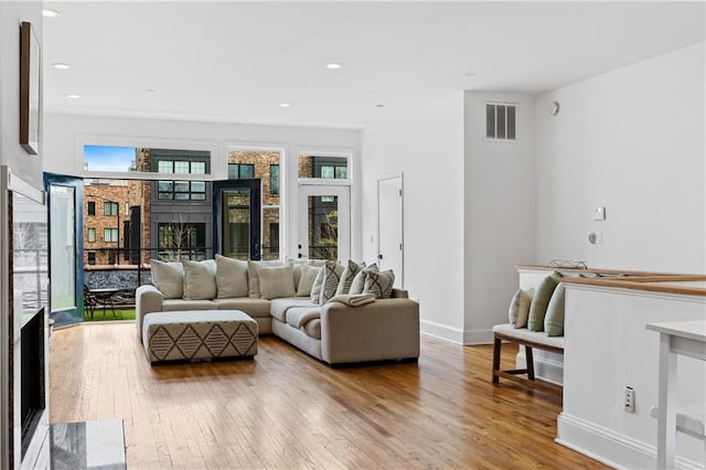 living room with a healthy amount of sunlight and light wood-type flooring