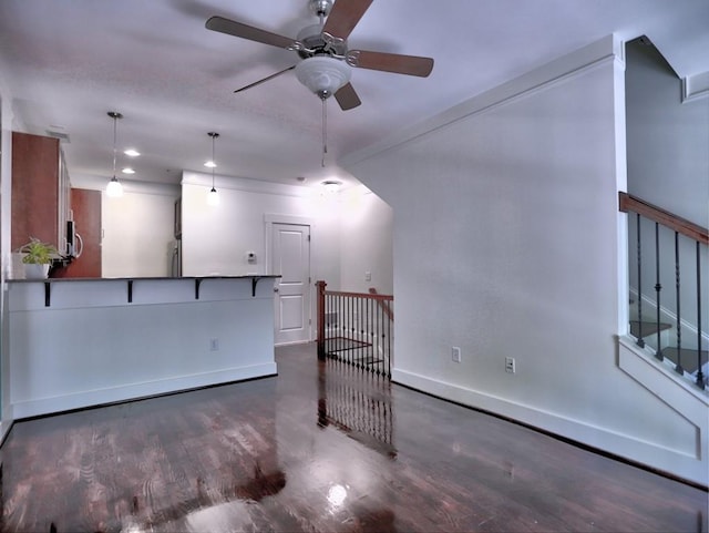 unfurnished living room with ceiling fan and dark hardwood / wood-style floors