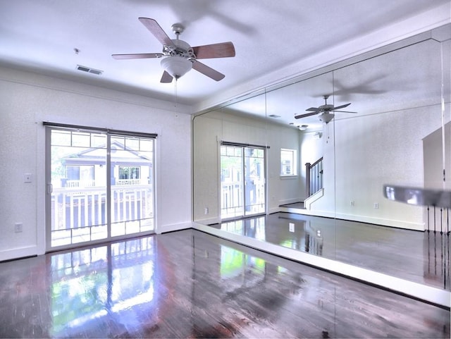 empty room featuring hardwood / wood-style floors and ceiling fan