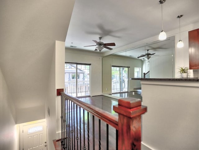 stairs featuring ceiling fan