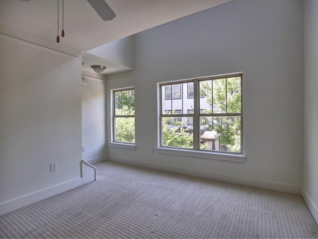 carpeted spare room with ceiling fan