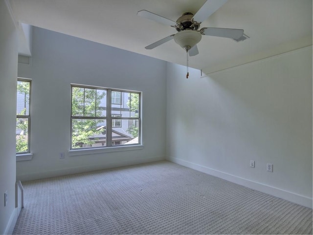 carpeted empty room featuring ceiling fan