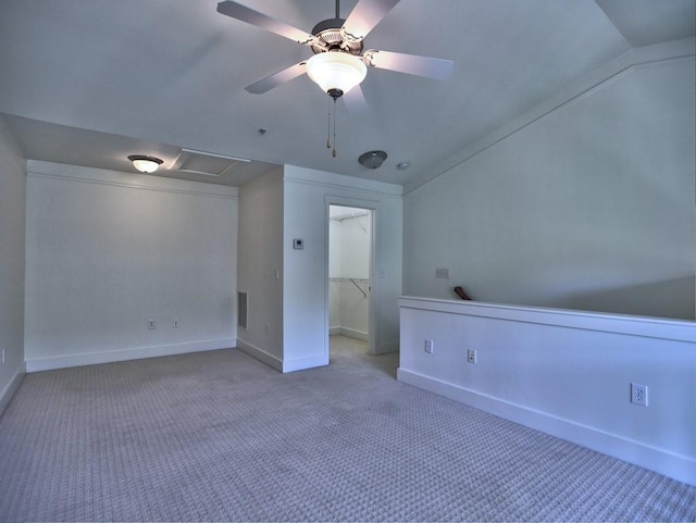 carpeted empty room featuring ceiling fan and vaulted ceiling