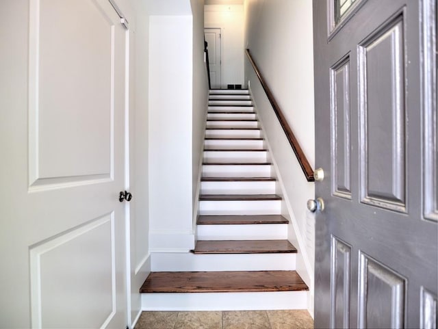 stairway featuring tile patterned floors