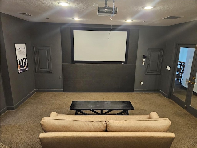 cinema with carpet and a textured ceiling