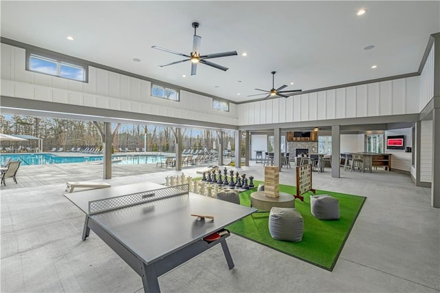 view of patio / terrace featuring a community pool, a ceiling fan, and outdoor dining area