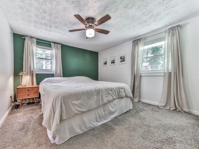 543 S Holly Springs Rd, Woodstock, GA 30188 - carpeted bedroom featuring a textured ceiling, baseboards, and ceiling fan