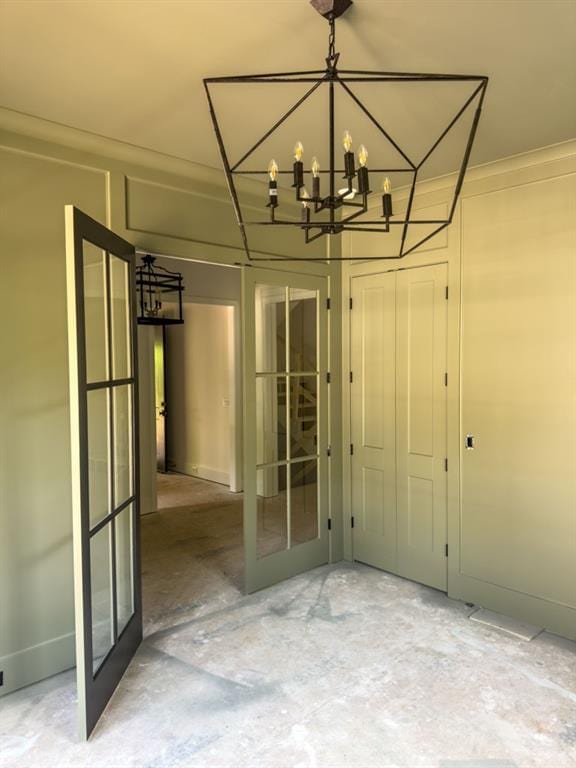 2461 Fernleaf Ct NW, Atlanta, GA 30318 - unfurnished dining area featuring french doors, concrete flooring, and a chandelier