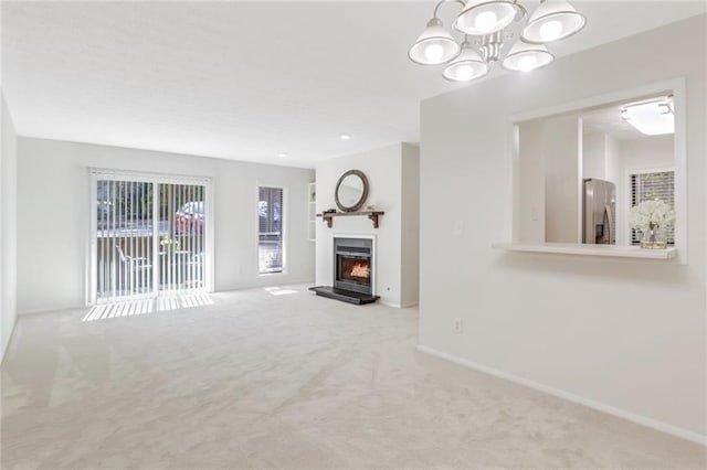 carpeted living room featuring a chandelier