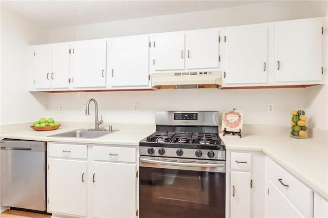 kitchen with stainless steel appliances, sink, a textured ceiling, and white cabinets