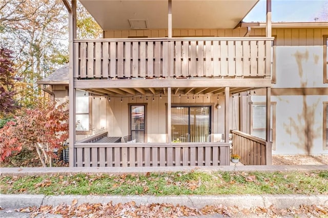 rear view of property featuring a balcony