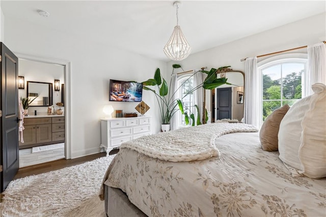 3667 Peachtree Rd NE Unit 6, Atlanta, GA 30319 - bedroom with a chandelier, baseboards, wood finished floors, and ensuite bath