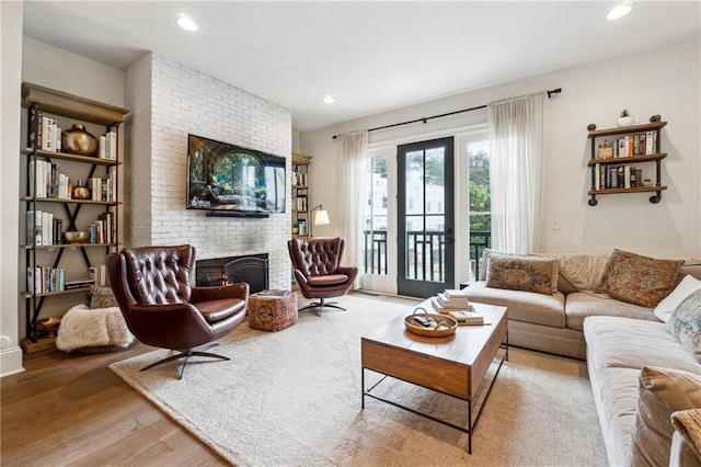 3667 Peachtree Rd NE Unit 6, Atlanta, GA 30319 - living room featuring wood finished floors, a fireplace, and recessed lighting