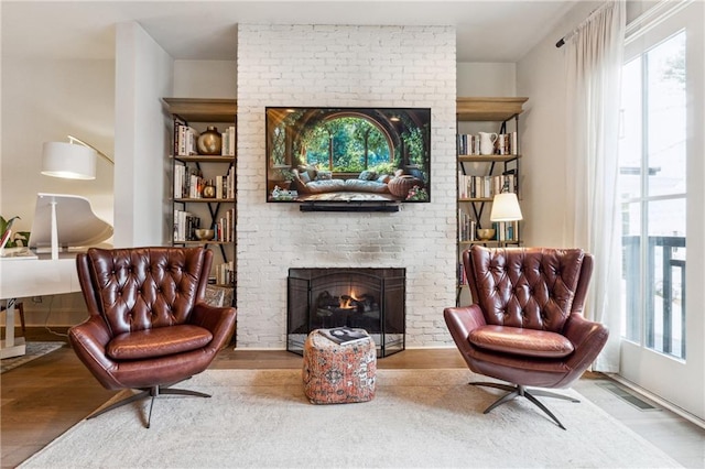 3667 Peachtree Rd NE Unit 6, Atlanta, GA 30319 - sitting room with wood finished floors and a fireplace